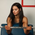 Beautiful sporty woman works out her arms in fitness gym Royalty Free Stock Photo