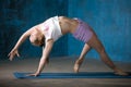 Beautiful sporty young woman Doing Camatkarasana posture