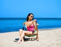 Beautiful, sporty and young woman in swimsuit using sun tan Royalty Free Stock Photo