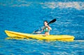 Beautiful sporty young woman in a yellow kanu kayak Royalty Free Stock Photo