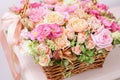 Flowers arrangement with various of colors in wicker basket on pink table. beautiful spring bouquet. bright room, white Royalty Free Stock Photo