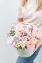 Beautiful spring bouquet in round box. Arrangement with various flowers. The concept of a flower shop. A set of photos Royalty Free Stock Photo