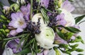 Beautiful spring bouquet wedding flowers buttercup ranunculus, fresia, lavender nature background. Pastel colors purple Royalty Free Stock Photo