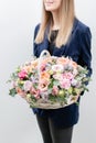 Beautiful spring bouquet in wicker basket. Arrangement with various flowers. The concept of a flower shop. A set of Royalty Free Stock Photo