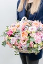 Beautiful spring bouquet in wicker basket. Arrangement with various flowers. The concept of a flower shop. A set of Royalty Free Stock Photo