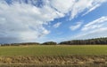 Beautiful spring day and the view from the car. Gorgeous landscape with fields, forest trees and blue sky with white clouds. Royalty Free Stock Photo