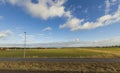 Beautiful spring day and the view from the car. Gorgeous landscape with fields, forest trees and blue sky with white clouds. Royalty Free Stock Photo