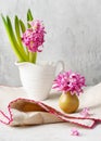 Beautiful spring floristic arrangement with pastel pink hyacinth flower in a mini vase.
