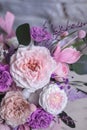 Beautiful spring Flowers in bouquet in pink and purpl color. Arrangement with Peonies roses. Flowers decor.