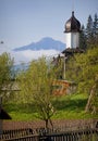 Beautiful spring landscape with church and mountain. Royalty Free Stock Photo