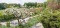 Beautiful spring landscape, city park munich Westpark, with blooming apple tree and seat group