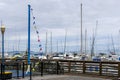 a beautiful spring landscape at Fisherman\'s Wharf on Pier 39 with boats and yachts docked in the harbor with ocean water Royalty Free Stock Photo