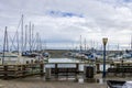 a beautiful spring landscape at Fisherman\'s Wharf on Pier 39 with boats and yachts docked in the harbor with ocean water Royalty Free Stock Photo