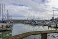 a beautiful spring landscape at Fisherman\'s Wharf on Pier 39 with boats and yachts docked in the harbor with ocean water Royalty Free Stock Photo