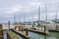 a beautiful spring landscape at Fisherman\'s Wharf on Pier 39 with boats and yachts docked in the harbor with ocean water Royalty Free Stock Photo