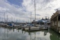 a beautiful spring landscape at Fisherman\'s Wharf on Pier 39 with boats and yachts docked in the harbor with ocean water Royalty Free Stock Photo