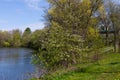 Beautiful spring landscape with mixed trees, river, church and patrimonial house in the background