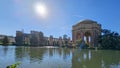 A beautiful spring landscape at Palace of Fine Arts with a lake, lush green trees and plants and beautiful buildings with blue sky