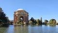 A beautiful spring landscape at Palace of Fine Arts with a lake, lush green trees and plants and beautiful buildings with blue sky