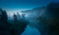 A beautiful spring landscape of a river valley with morning mist. Springtime scenery of a river flowing through the forest. Royalty Free Stock Photo