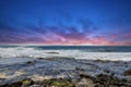 a beautiful spring landscape at Sandy Beach with blue ocean water, silky brown sand, rocks covered in green algae, crashing waves Royalty Free Stock Photo