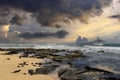 a beautiful spring landscape at Sandy Beach with blue ocean water, silky brown sand, rocks covered in green algae, crashing waves Royalty Free Stock Photo