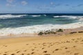 a beautiful spring landscape at Sandy Beach with blue ocean water, silky brown sand, rocks Royalty Free Stock Photo