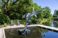 a beautiful spring landscape in the Sculpture Garden at New Orleans City Park with a lake, lush green trees, grass and plants