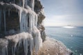 Beautiful spring landscape sea view. Frozen waterfall on the beach, melting ice in sunlight