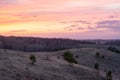 Beautiful spring landscape: sunset, trees, forest, mountains, hills, fields, meadows and sky. Gorgeous, red sky with heavy clouds Royalty Free Stock Photo