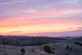 Beautiful spring landscape: sunset, trees, forest, mountains, hills, fields, meadows and sky. Gorgeous, red sky with heavy clouds Royalty Free Stock Photo