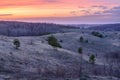 Beautiful spring landscape: sunset, trees, forest, mountains, hills, fields, meadows and sky. Gorgeous, red sky with heavy clouds Royalty Free Stock Photo