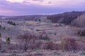 Beautiful spring landscape: sunset, trees, forest, mountains, hills, fields, meadows and sky. Gorgeous, red sky with heavy clouds Royalty Free Stock Photo