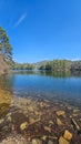 A beautiful spring landscape at Unicoi Lake with rippling blue water and lush green trees, grass and plants at Unicoi State Park Royalty Free Stock Photo