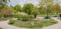 Beautiful spring landscape with walkways flower beds and benches, Westpark Munich Royalty Free Stock Photo