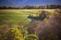 Beautiful spring landscape in warm sunset light. Trees meadows, fields and hunting cabine Royalty Free Stock Photo