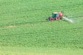 Beautiful spring landscape with working spraying water tractor on green field in South Moravia, Czech Republic. Agriculture irriga Royalty Free Stock Photo