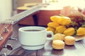 Beautiful spring music background. Cup of coffww, guitar, yellow