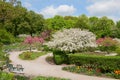 Beautiful spring park landscape, Westpark munich, recreational area with benches and blooming apple trees and tulips Royalty Free Stock Photo