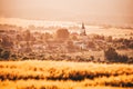 Beautiful spring rural landscape, yellow agricultural field, church and village Royalty Free Stock Photo