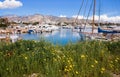 Beautiful spring season in Glyfada harbor with spring flowers, moored boats, calm sea, blue sky of suburb in South Athens located