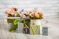 Beautiful spring still life with flowers and wooden love letters Royalty Free Stock Photo