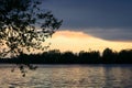 Spring sunset on the river with a beatiful sky in pastel colors and silhoettes of trees.