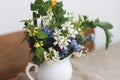 Beautiful spring wildflowers in vintage cup on rustic wooden table. Blooming rural colorful flowers Royalty Free Stock Photo