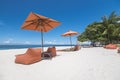 Beautiful square parasol and lounge chairs at a luxury white sand beachfront resort in Dumaluan Beach, Panglao Island, Bohol, Royalty Free Stock Photo