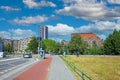 Beautiful square park with skyline of dutch city, blue summer sky fluffy whiteclouds Royalty Free Stock Photo