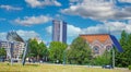 Beautiful square park with skyline of dutch city, blue summer sky fluffy whiteclouds Royalty Free Stock Photo