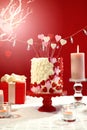 Valentines Day party table with showstopper hearts cake with lens flare. Royalty Free Stock Photo