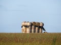 Beautiful stacked straw bullets creating an artistic figure in the field Royalty Free Stock Photo