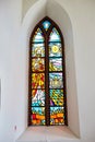 Beautiful stained multi-colored glass window in the catholic church Royalty Free Stock Photo